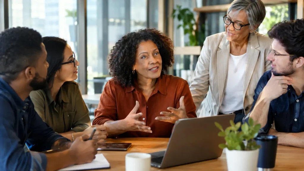 Equipa de trabalho multigeracional em ambiente respeitoso e colaborativo
